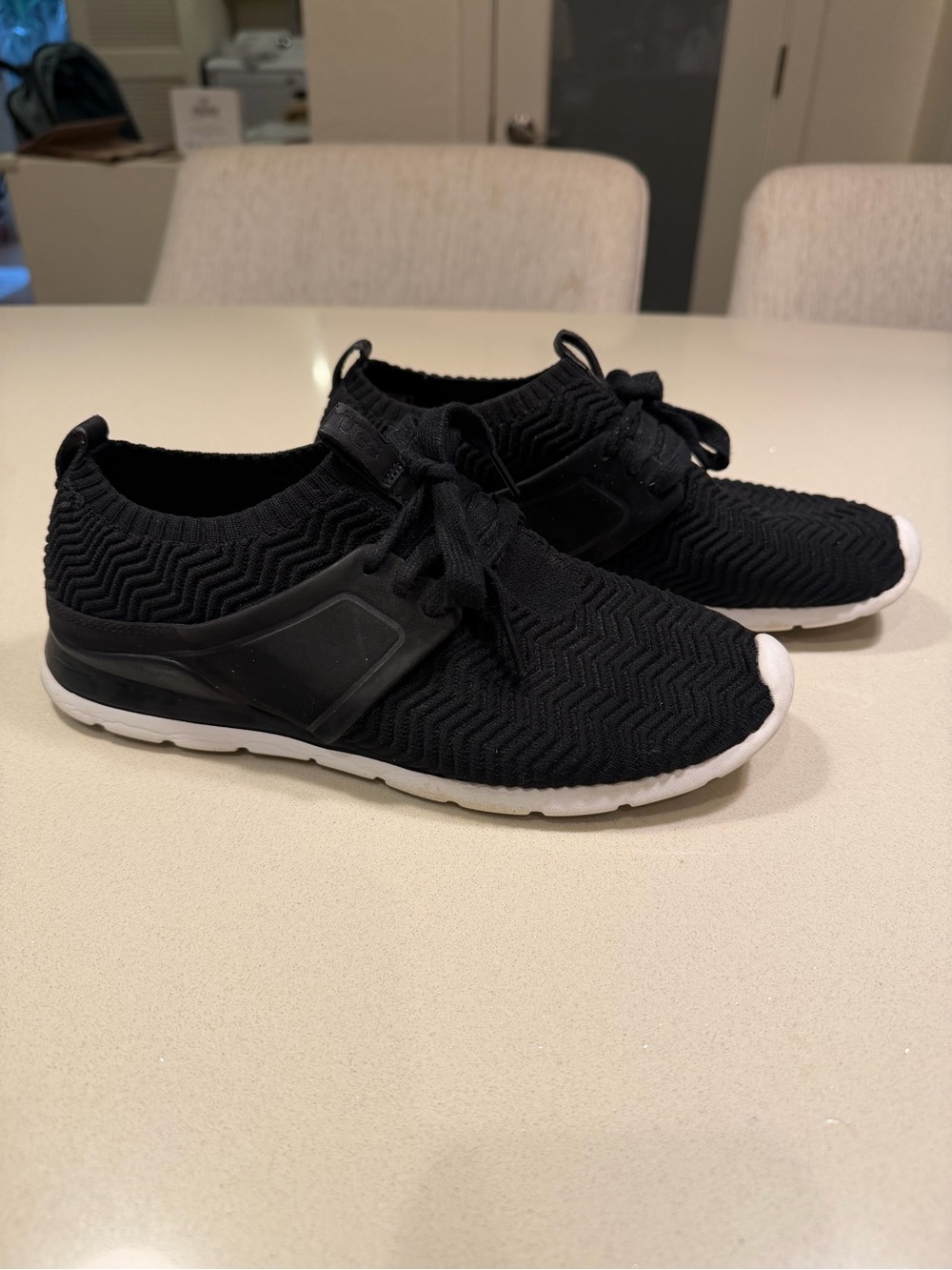 UGG women’s Willow Black Knit Slip-On Sneakers with White Sole